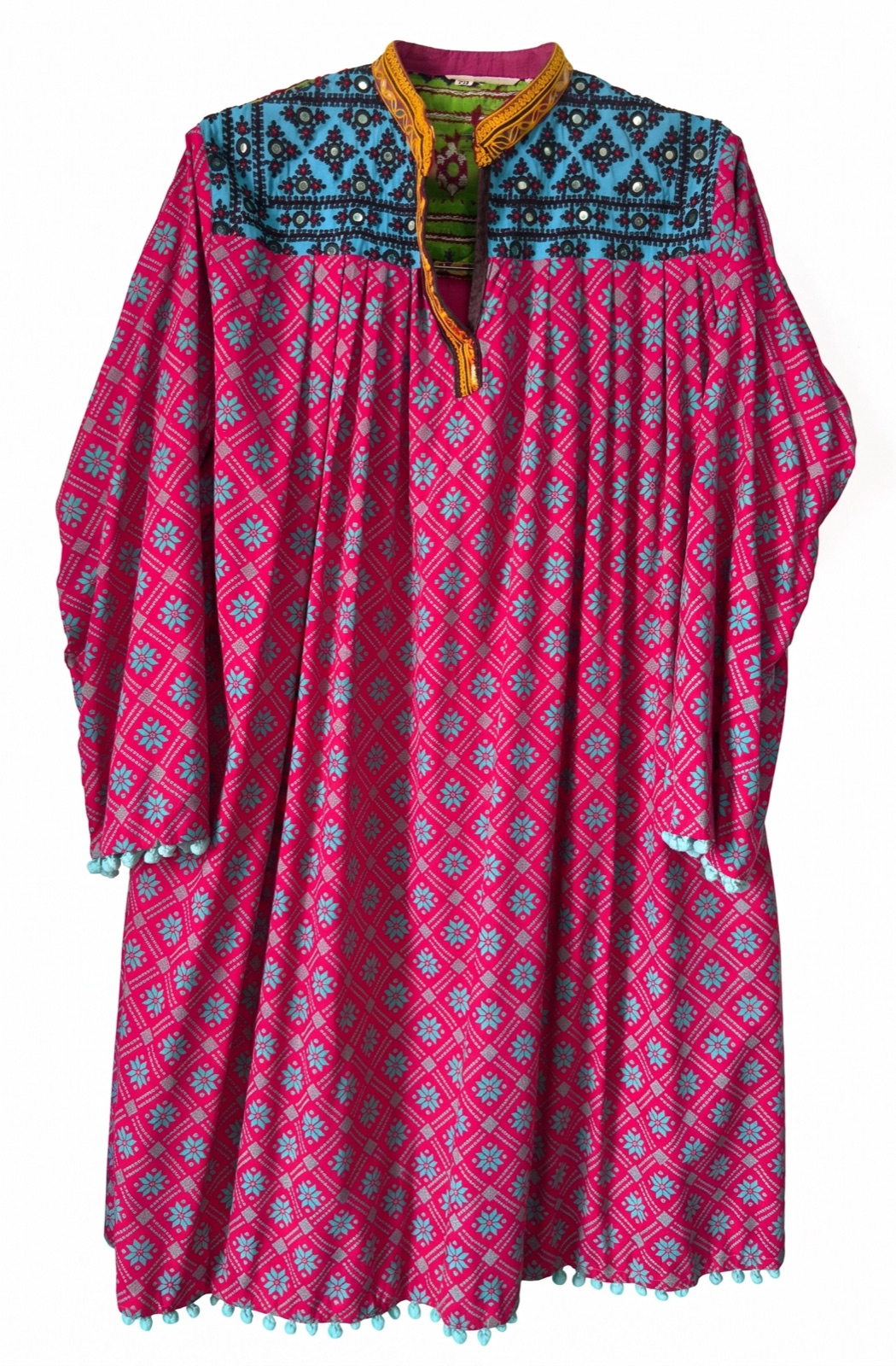 Hand-embroidered magenta kurta with a turquoise mirror-work yoke, handmade by women artisans in Tharparkar, Sindh